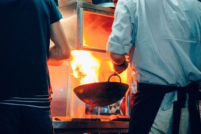 Chef cooking at stove with flaming pan