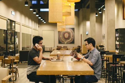 Full length of a man sitting in restaurant