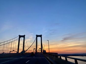 View of suspension bridge against sky during sunset