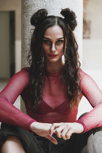 Portrait of young woman sitting outdoors