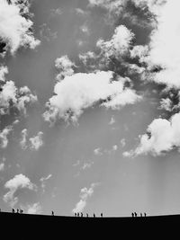 Low angle view of horses against sky