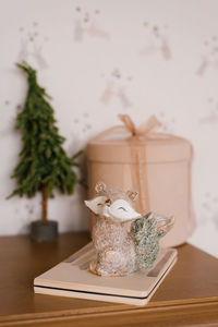 Decor on the shelf in the children's room. souvenir christmas tree, gift box, notebook