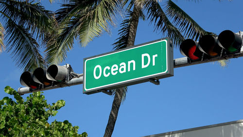 Low angle view of road sign against sky