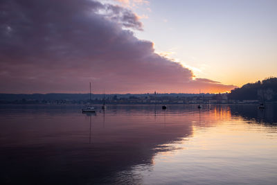 Scenic view of lake against sky during sunset