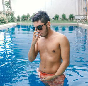 Young man looking at swimming pool