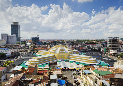High angle view of buildings in city against cloudy sky