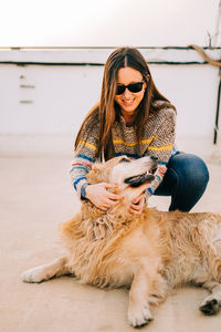 Woman playing with dog on building terrace