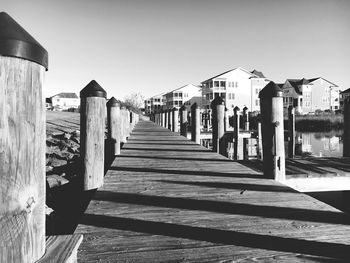 Pier on beach against clear sky