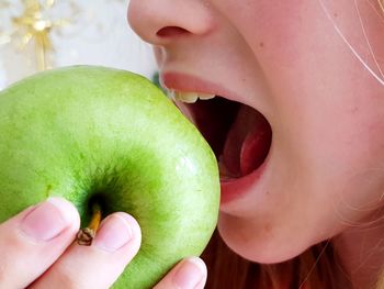 Close-up of woman holding apple