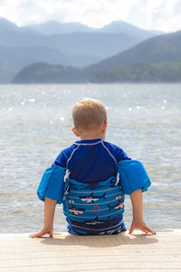 Rear view of boy looking at sea