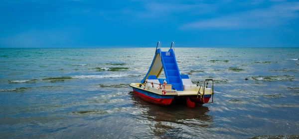Sailboat in sea against sky
