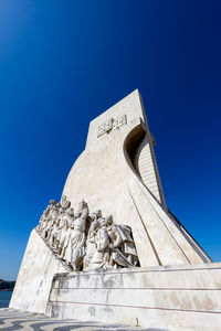 Low angle view of statue against clear blue sky