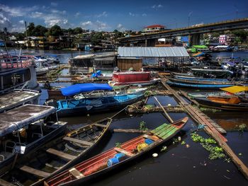 High angle view of boats moored at harbor against sky