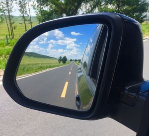 Reflection of car on side-view mirror