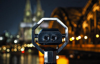 Close-up of illuminated lighting equipment on street at night