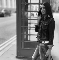 Full length of young woman photographing