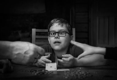 Portrait of boy holding table