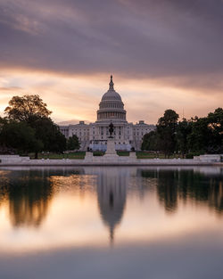 Reflection of building in lake at sunset