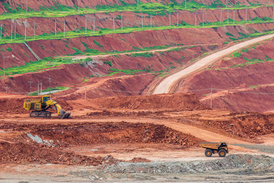 Construction vehicles against mountains