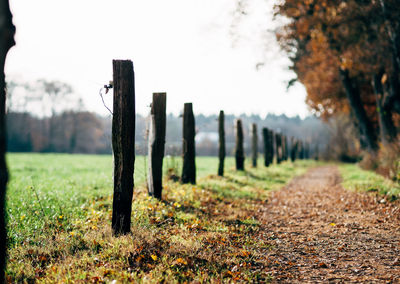 Fence on field against sky