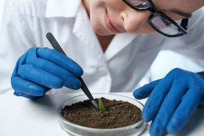 Midsection of scientist examining soil