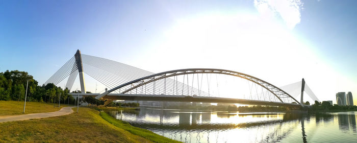 Bridge over river with city in background