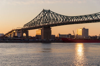 View of bridge over river during sunset