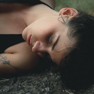 Close-up of woman lying down in forest