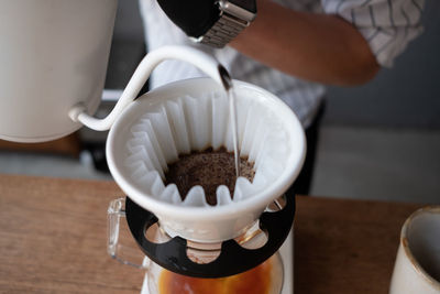 Barista dripping coffee and slow coffee bar style