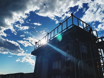 Low angle view of silhouette building against sky