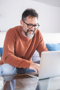 Young man using laptop at home