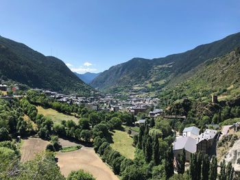Scenic view of townscape against mountains