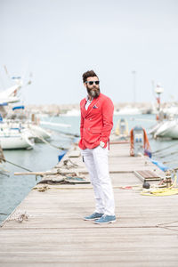 Portrait of a man standing on a pier