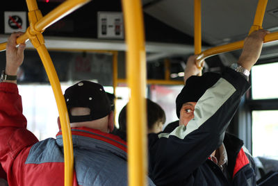 Rear view of people sitting in train