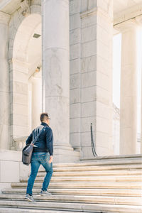 Full length of man standing on staircase against building