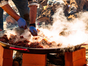 Man preparing food at market stall