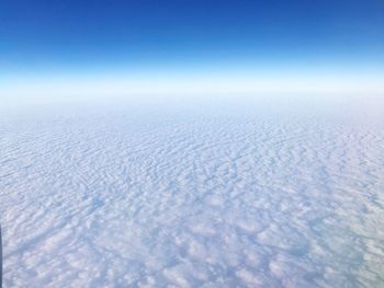 Scenic view of snow landscape against blue sky