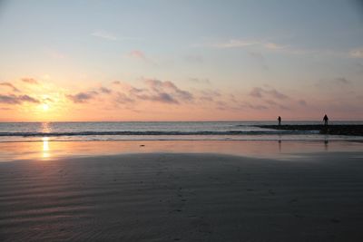 Scenic view of beach against sky during sunset