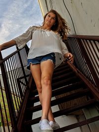 Portrait of beautiful young woman on staircase