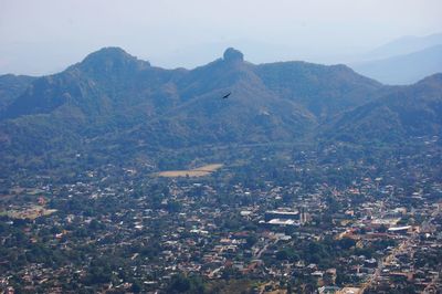 High angle view of townscape and mountains against sky