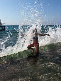 Man surfing in sea against sky
