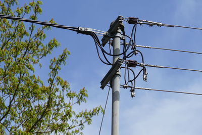 Low angle view of electricity pylon against sky