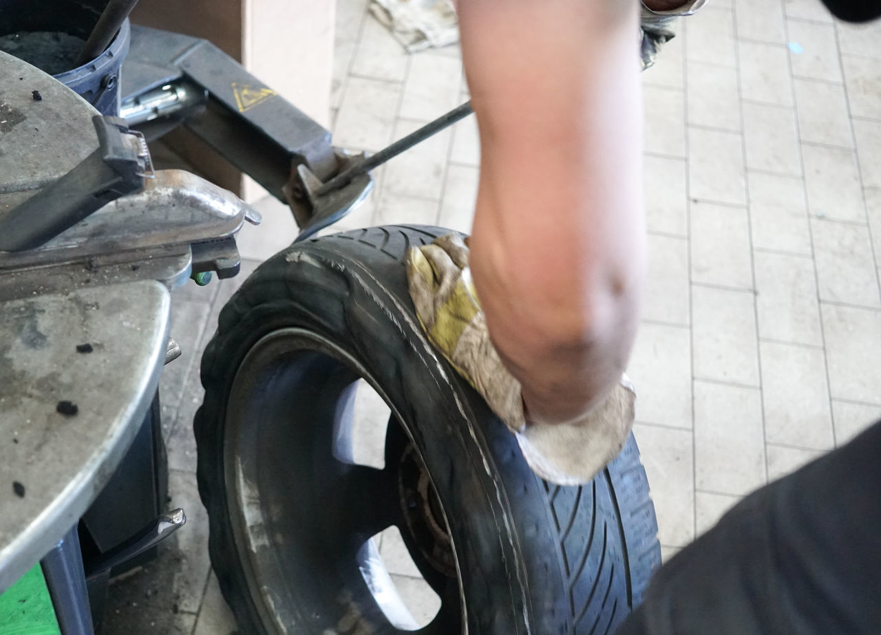 LOW SECTION OF MAN WORKING ON VEHICLE