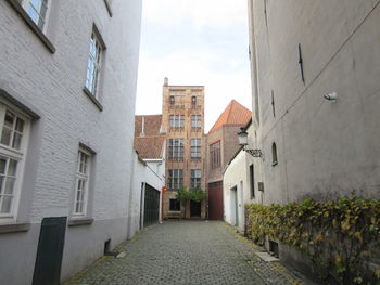 Street amidst buildings against sky