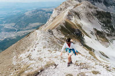 Rear view of woman walking on mountain