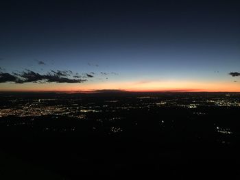 Silhouette cityscape against sky during sunset