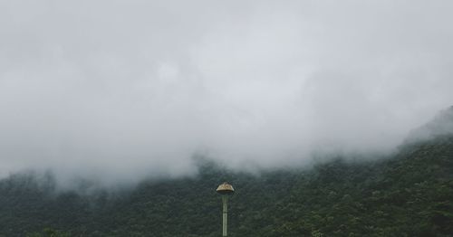 Scenic view of foggy weather against sky