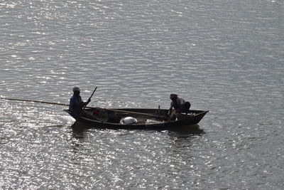 Men sitting in boat on sea