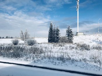 Snow covered field against sky