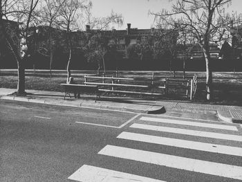 Empty road with trees in background